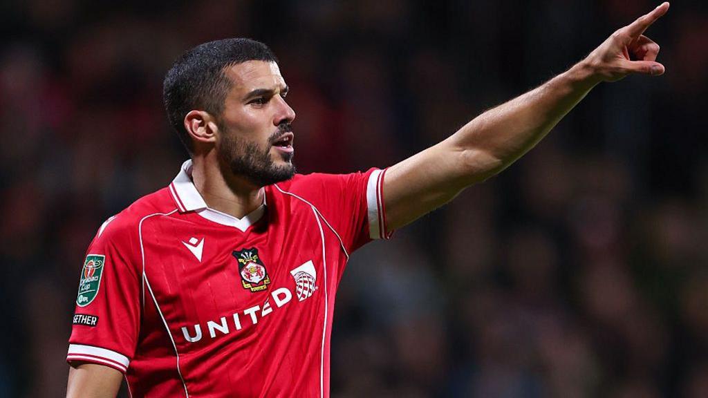 Coady Coady points to the sky while playing for Wrexham