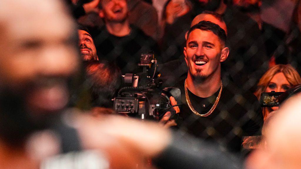 Tom Aspinall grins at cageside