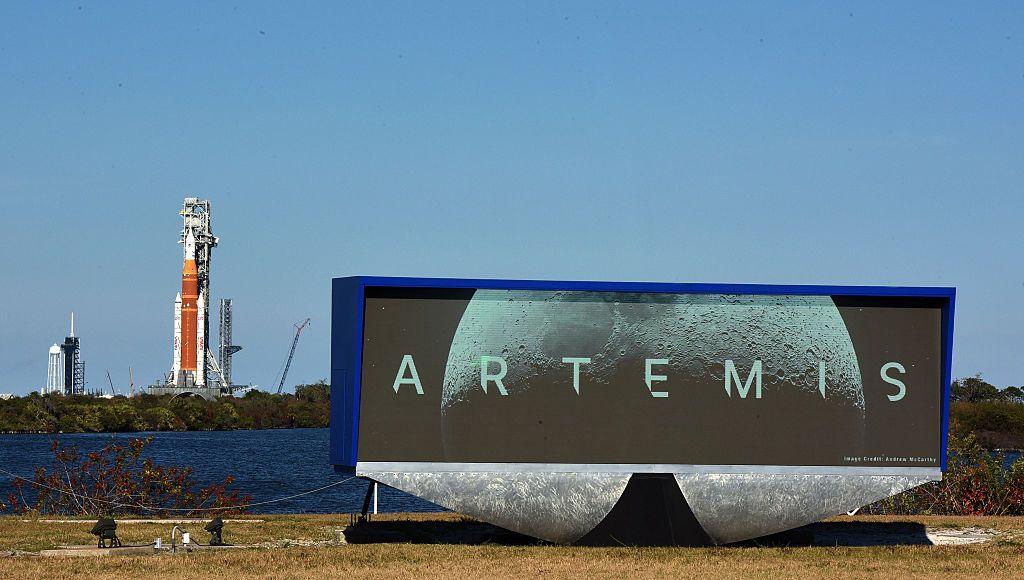 Artemis II Space Launch System (SLS) rocket with the Orion spacecraft is seen behind the NASA press site countdown clock.