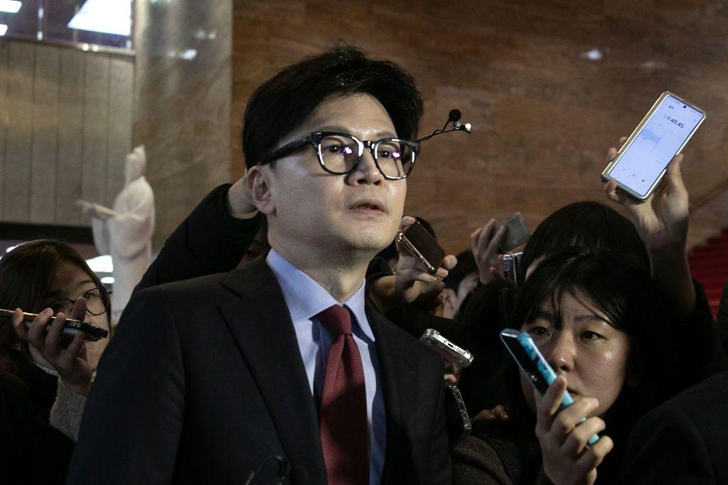 Han Dong-hoon surrounded by reporters as leaves the party's meeting at the National Assembly in Seoul