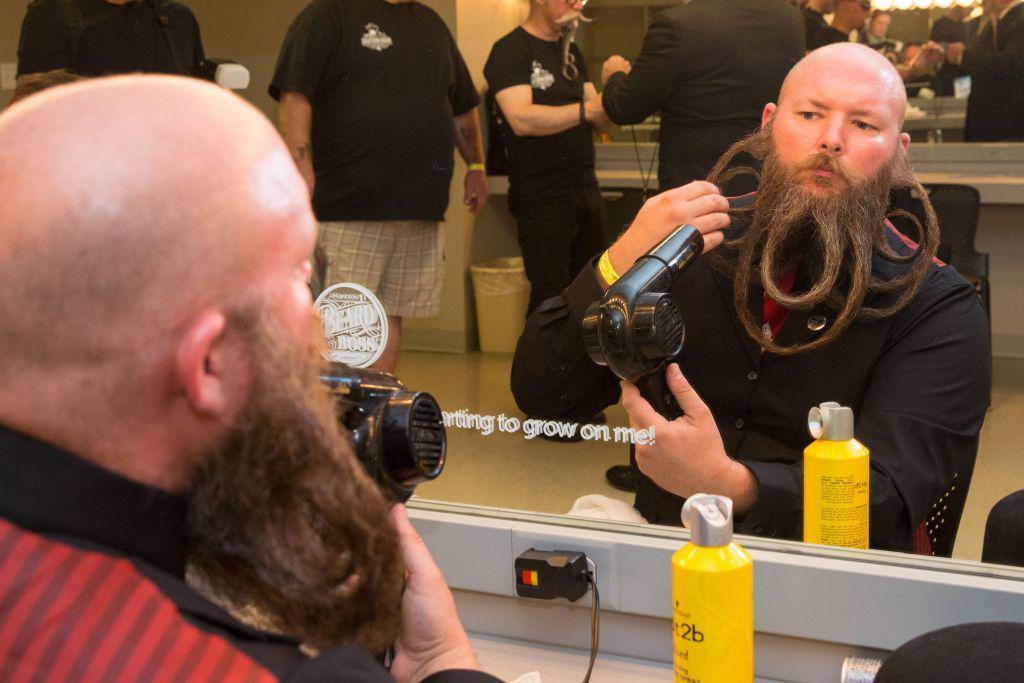 A competitor prepares his beard during the 2017 World Beard and Moustache Championships