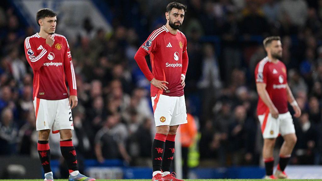 Manchester United players look disappointed after defeat at Chelsea