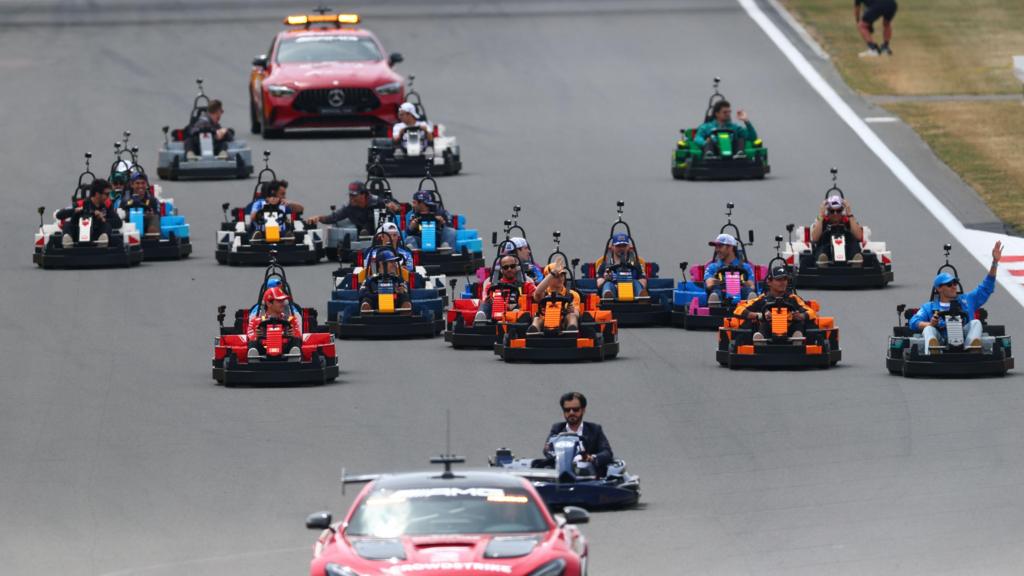 The F1 drivers come down the Hangar straight in Lego minicars in their team's colours before the British Grand Prix at Silverstone