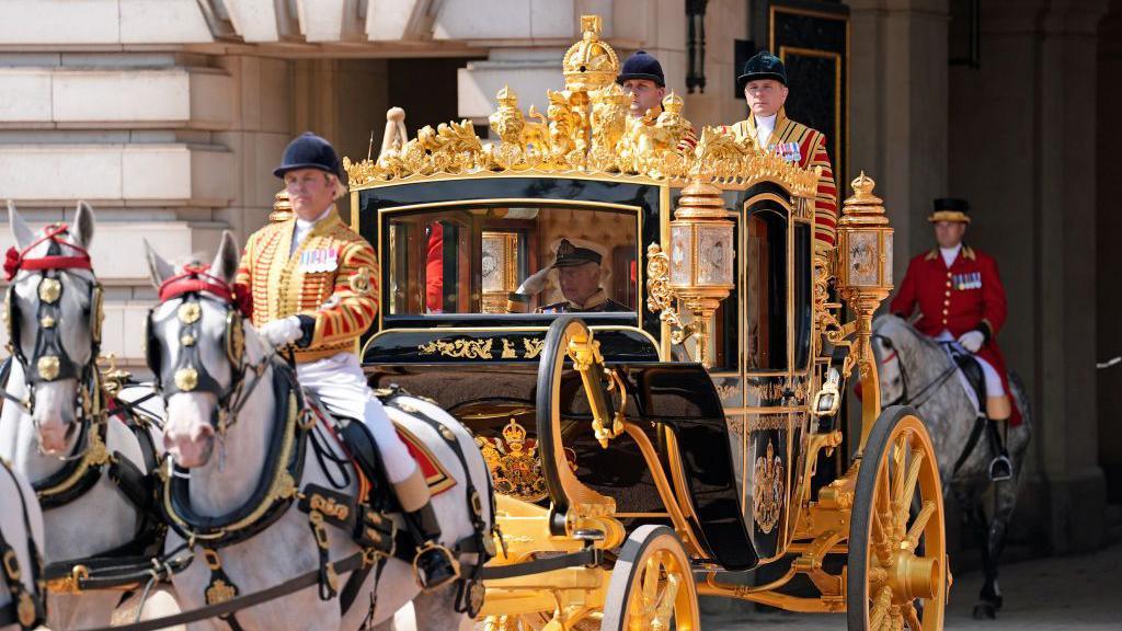 King Charles III and Queen Camilla depart Buckingham Palace, travelling in the Diamond Jubilee State Coach to the State Opening of Parliament in 2024.