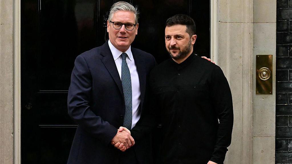 Keir Starmer shakes hands with Volodymyr Zelensky as he greets him on the steps of 10 Downing Street