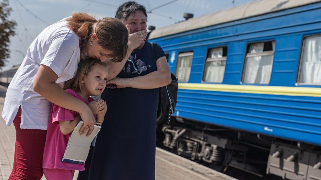 Crying Ukrainians near a train in Pokrovsk