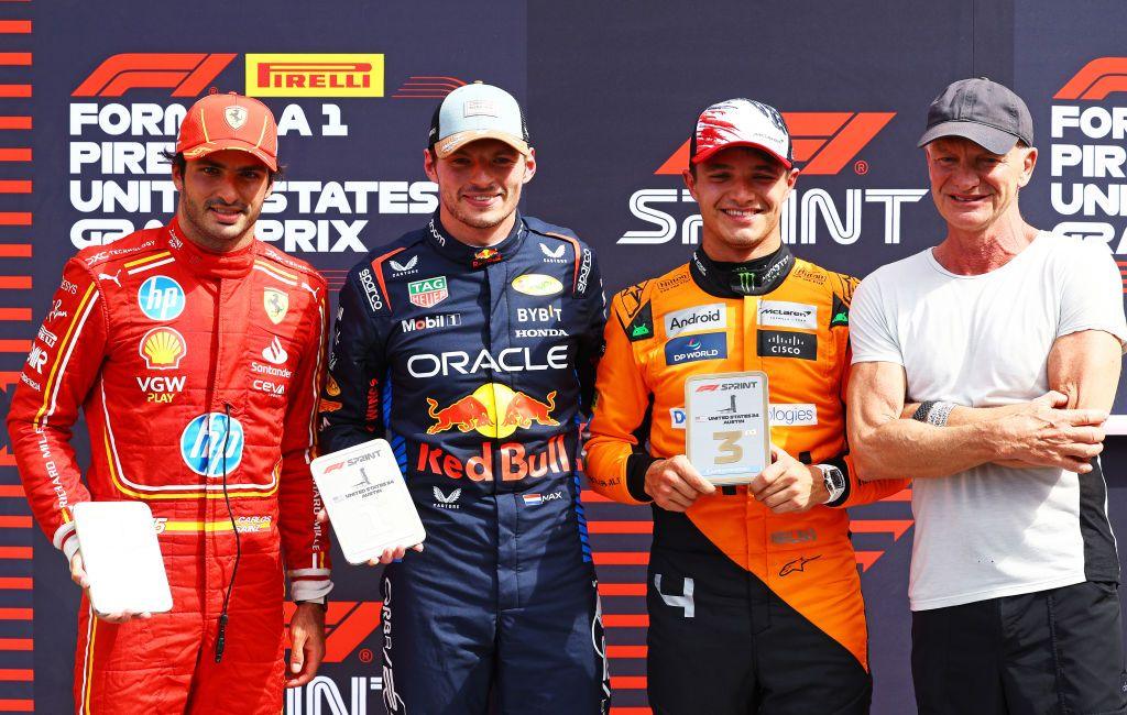 The top three drivers in the US Grand Prix sprint race, Max Verstappen, Carlos Sainz and Lando Norris, pose for pictures with singer Sting who presented them with their trophies