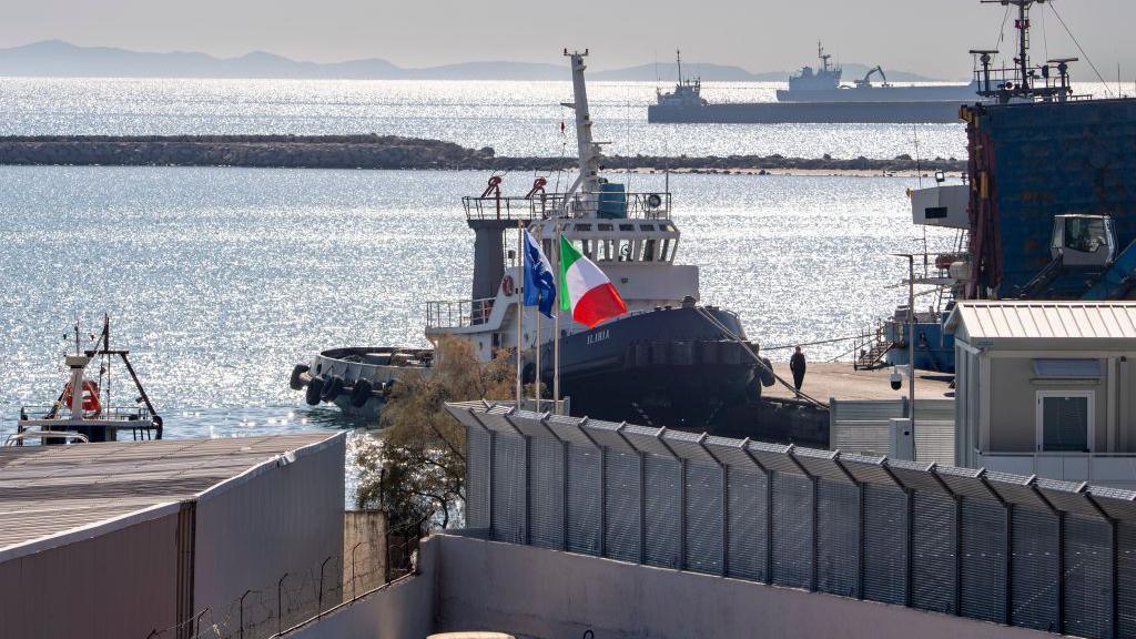 A boat arrives at one of two Italian migrant centres set up in Albania to process asylum seekers