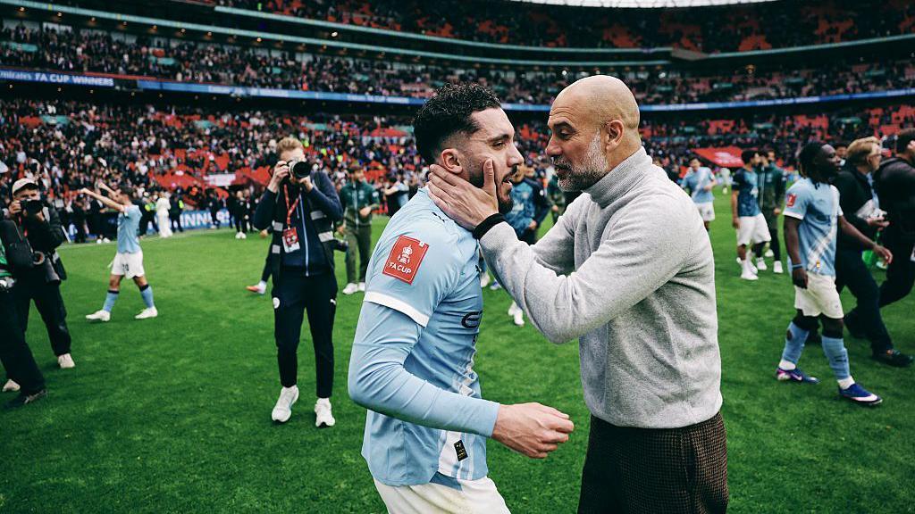 Pep Guardiola embraces Rayan Cherki at full-time of Manchester City's win over Chelsea in May's FA Cup final