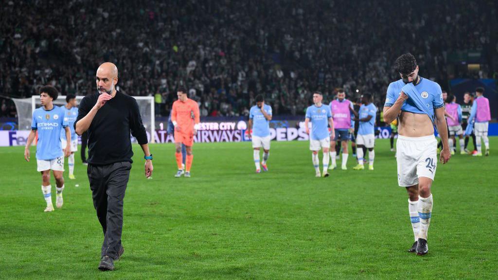 Pep Guardiola walks off the pitch with his players after the Brighton loss