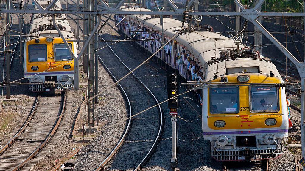 Crowded commuter trains of the Western Railway near Mahalaxmi Station on the Mumbai Suburban Railway.