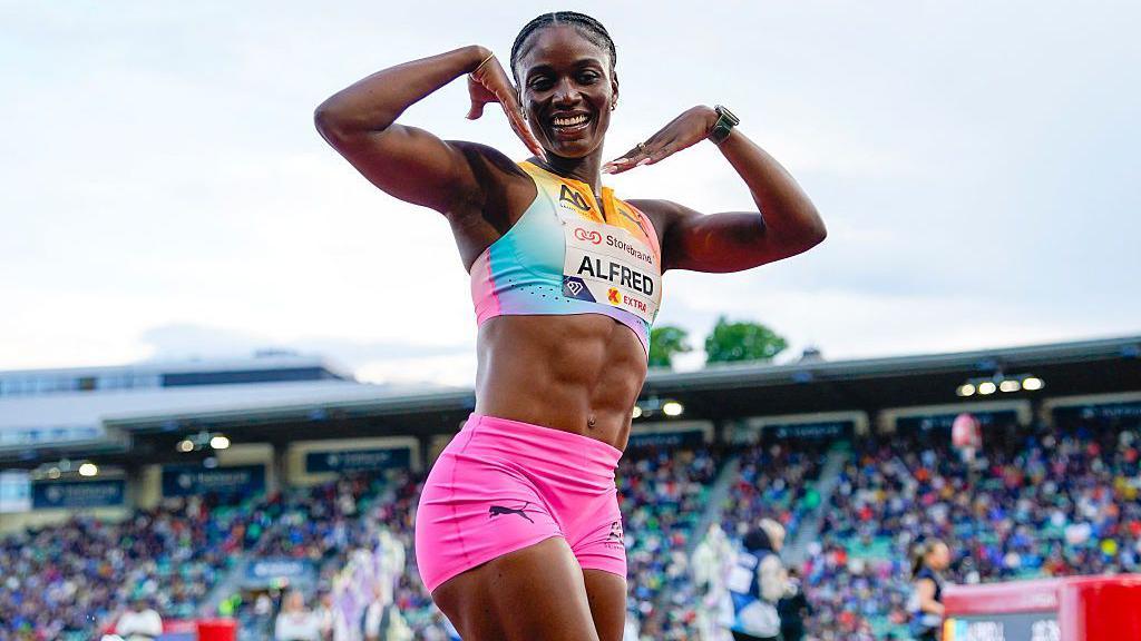 Julien Alfred celebrates with her hands by her face and smiling after winning the Women's 100m run event of the Oslo Diamond League.