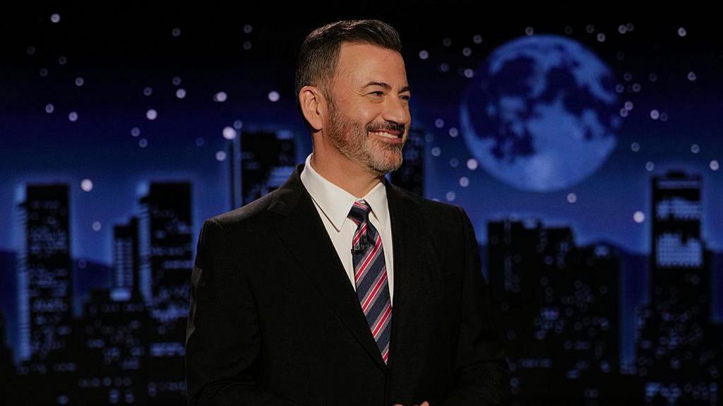 Jimmy Kimmel delivers his monologue standing on stage of his show 