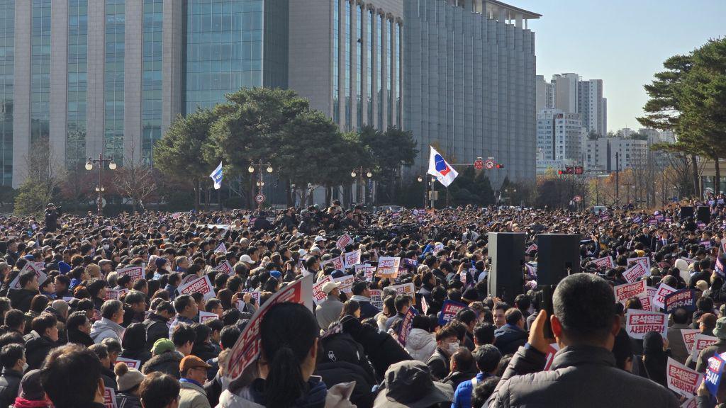 People, gathered in front of the National Assembly Building, protest following the declaration of martial law in Seoul, South Korea on December 04, 2024. 