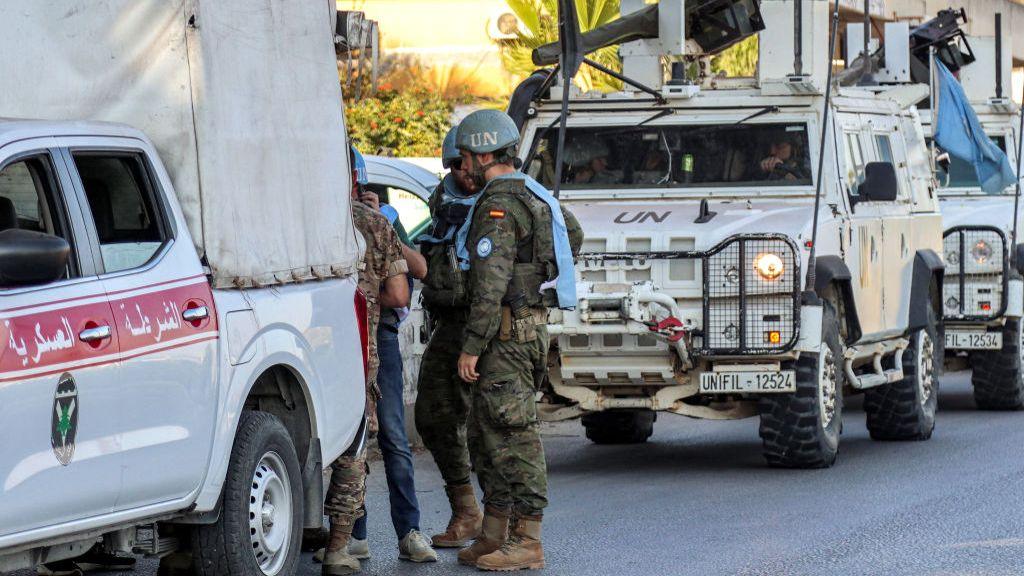 Spanish peacekeepers of the United Nations Interim Force in Lebanon (UNIFIL) coordinate their patrol with the Lebanese Military Police, in Marjayoun in south Lebanon on October 8, 2024.