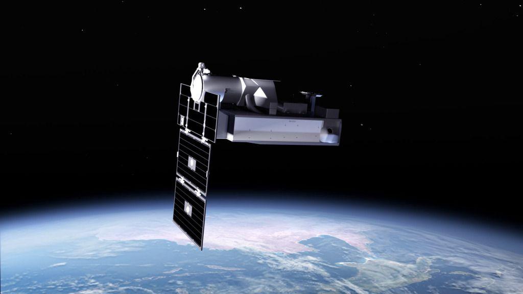 An artists impression of the satellite. It is a metallic silver colour and has black solar panels on it's front. It is depicted as being in space, above earth.