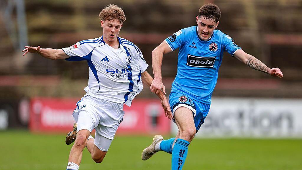 Luca Vozar of Schalke 04 in action against Dawson Devoy of Bohemians during the mid-season friendly match between Bohemians and Schalke 04 at Dalymount Park in Dublin