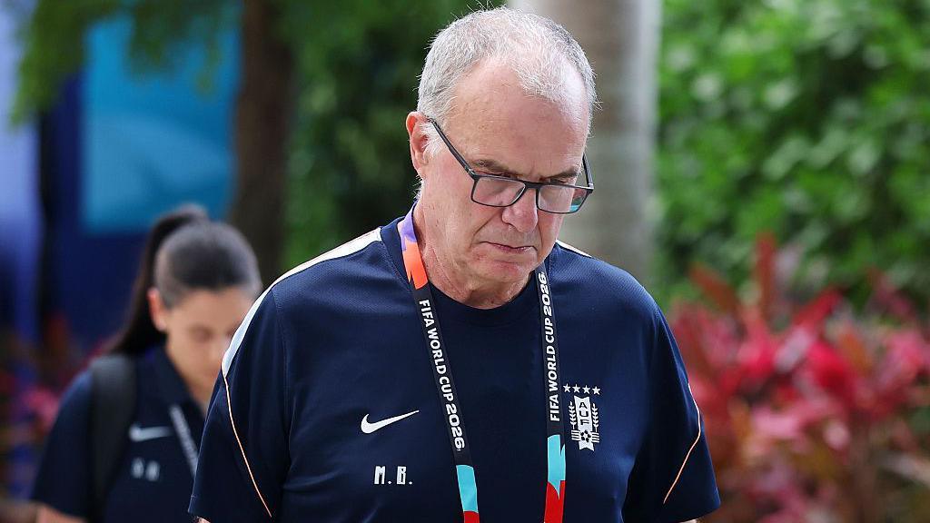Close-up of Marcelo Bielsa in a Uruguay training shirt, looking downwards