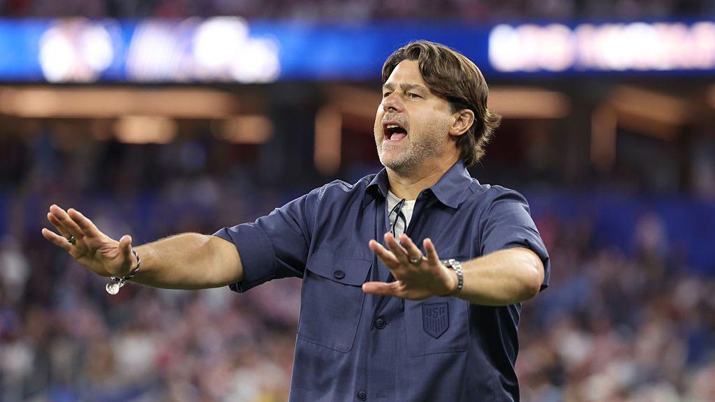 United Stats head coach Mauricio Pochettino gestures to his players with his arms outstretched 