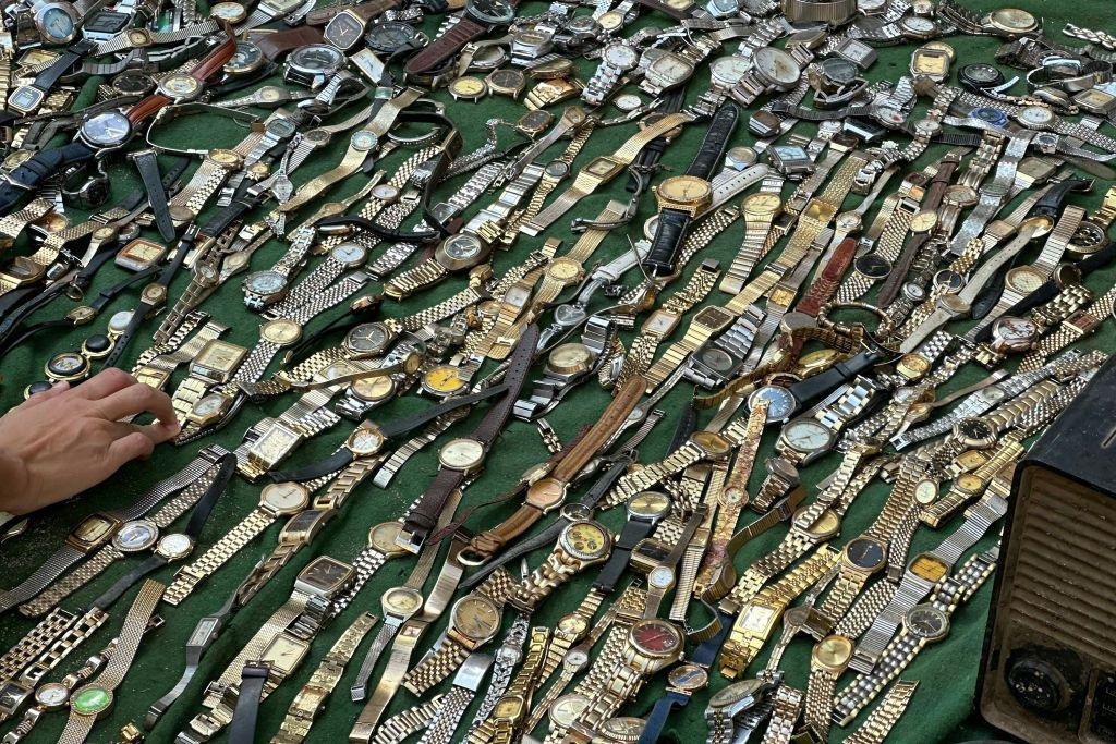 An Egyptian street vendor displays watches for sale at the Saturday market in downtown Cairo.