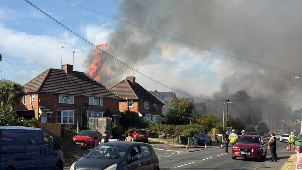 Fire raging above a house.