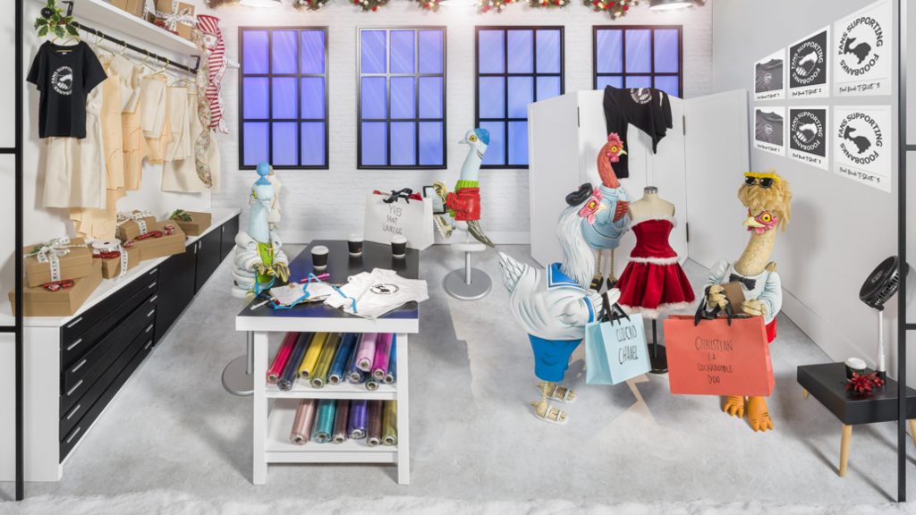 One of the scenes which shows a white workshop where lots of fabrics are present. Some of the characters are holding shopping bags. 