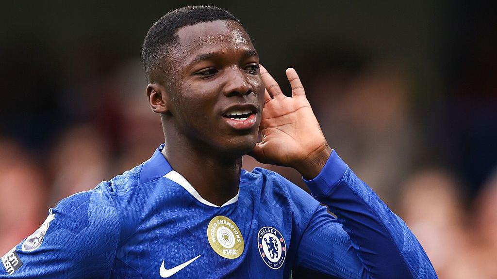 Moises Caicedo cups his hand to his ear to celebrate his goal against Liverpool