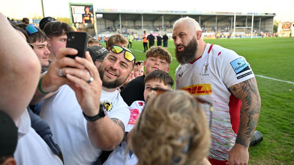 Joe Marler poses for a selfie with Harlequins fans.