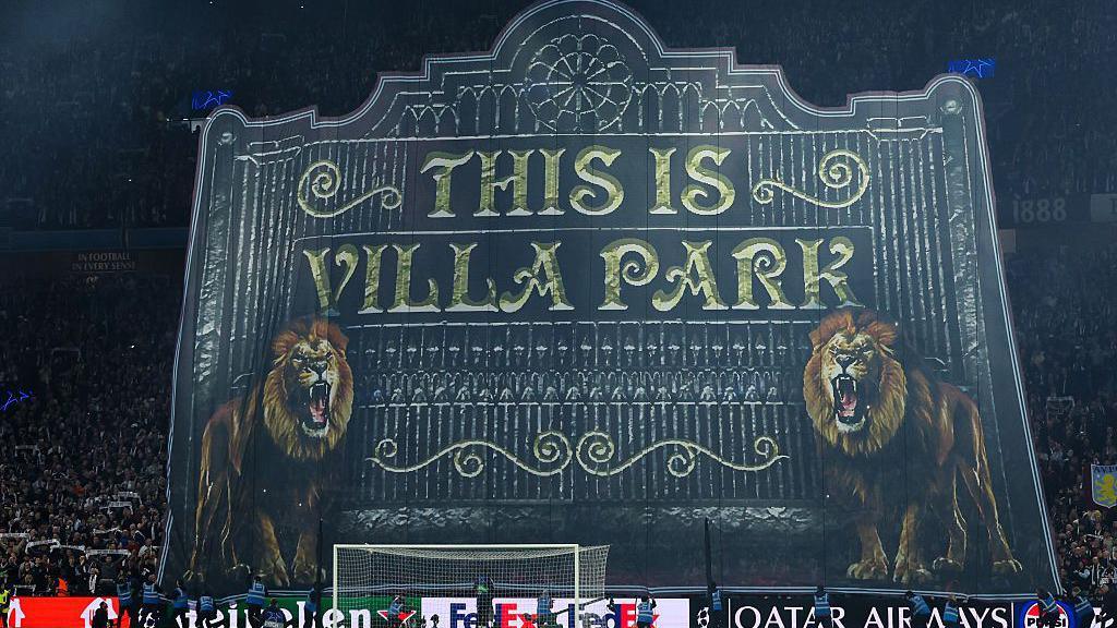 Aston Villa's tifo prior to their Champions League tie with Paris St-Germain. It is a reproduction of the outside of the stadium, reading "This is Villa Park" with a picture of the gates and the Villa lions alongside it.