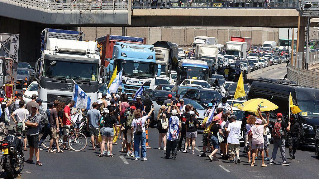 Demonstrators block a road during a protest in Tel Aviv demanding a deal to release hostages detained in the Gaza Strip