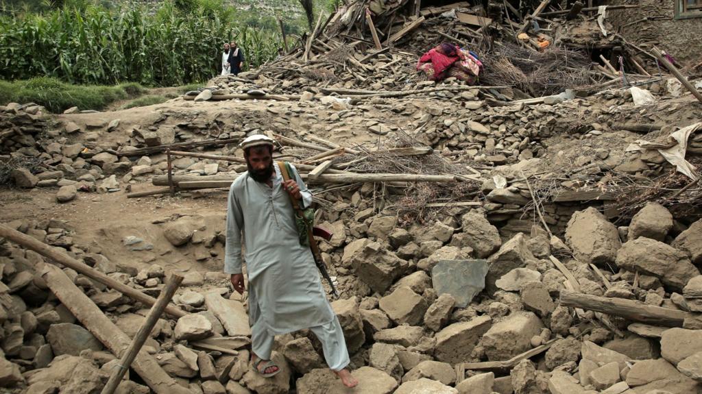 A man walks through rubble