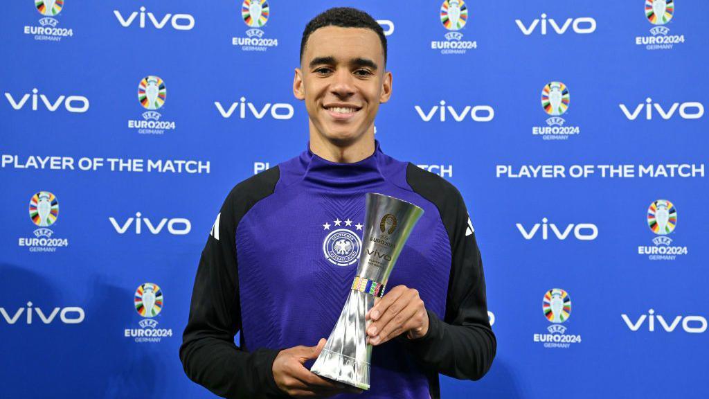 Jamal musiala with the player of the match euro trophy