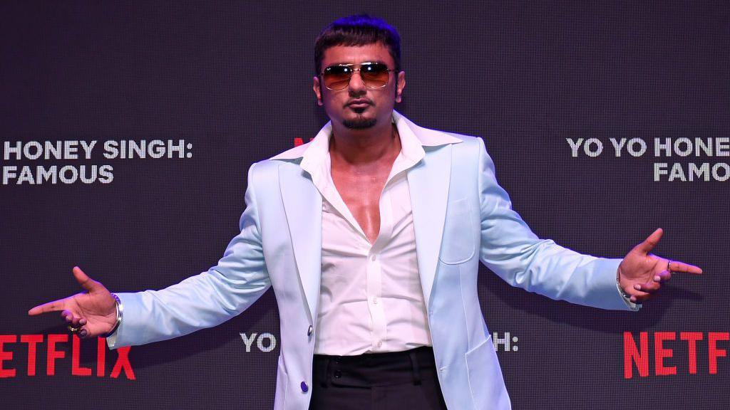 Indian music producer and actor Hirdesh Singh (professionally known as Yo Yo Honey Singh) wearing a light blue blazer with a white shirt and black trousers with oversized sunglasses poses for a photo at an event to unveil his upcoming documentary 'Yo Yo Honey Singh : Famous' on Netflix in Mumbai. 