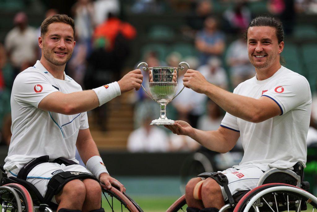 Alfie and Gordon holding up the Wimbledon trophy