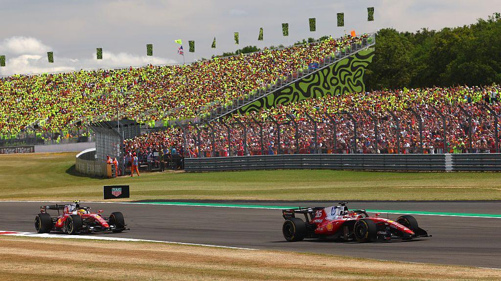 Ferrari's Charles Leclerc races ahead of team-mate Lewis Hamilton in front of the Lando Stand in Silverstone at the British Grand Prix