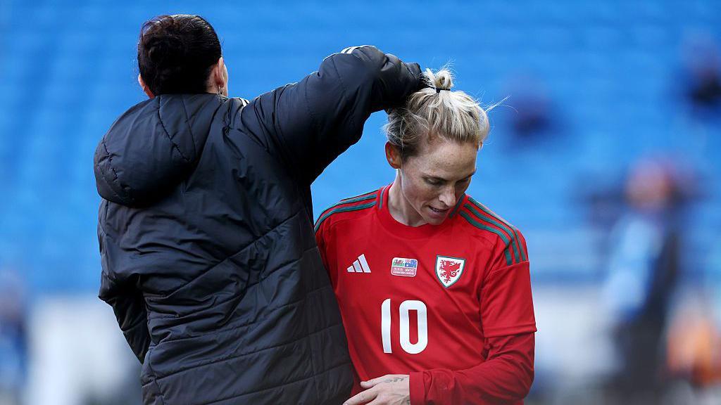 Rhian Wilkinson taps Jess Fishlock on the back after her final Wales appearance against Australia 