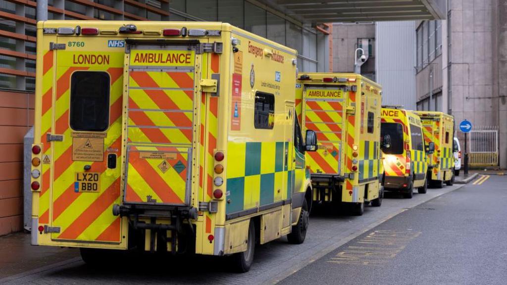 A queue of ambulances outside