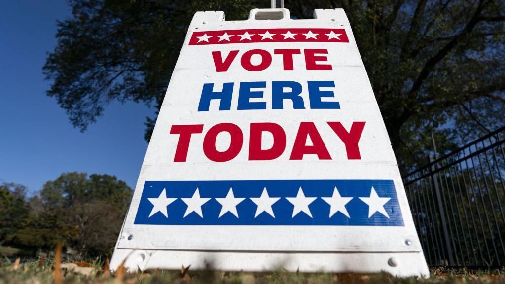 A sign outside a voting station in the U.S. that reads "vote here today".