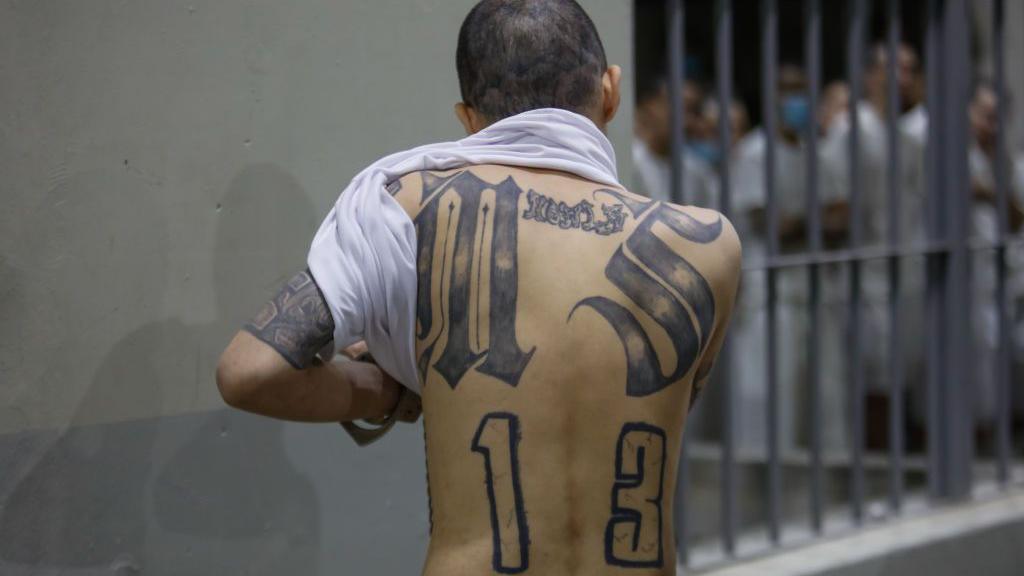 An inmate shows his back tattoos at CECOT (Spanish acronym for counter-terrorism confinement center) in Tecoluca on February 6, 2024 in San Vicente, El Salvador. 