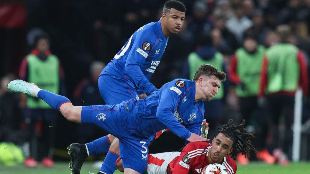 Rangers defender Ridvan Yilmaz lands on Manchester United's Leny Yoro during the Europa League encounter at Old Trafford