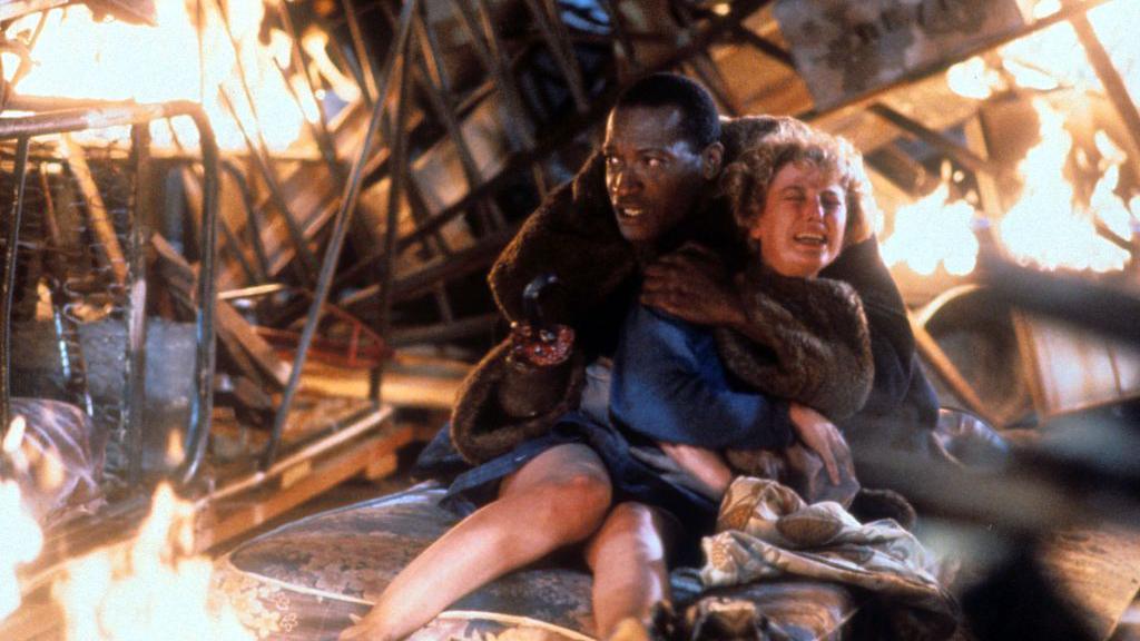 Todd holding on to Virginia Madsen in a scene from 1992's Candyman