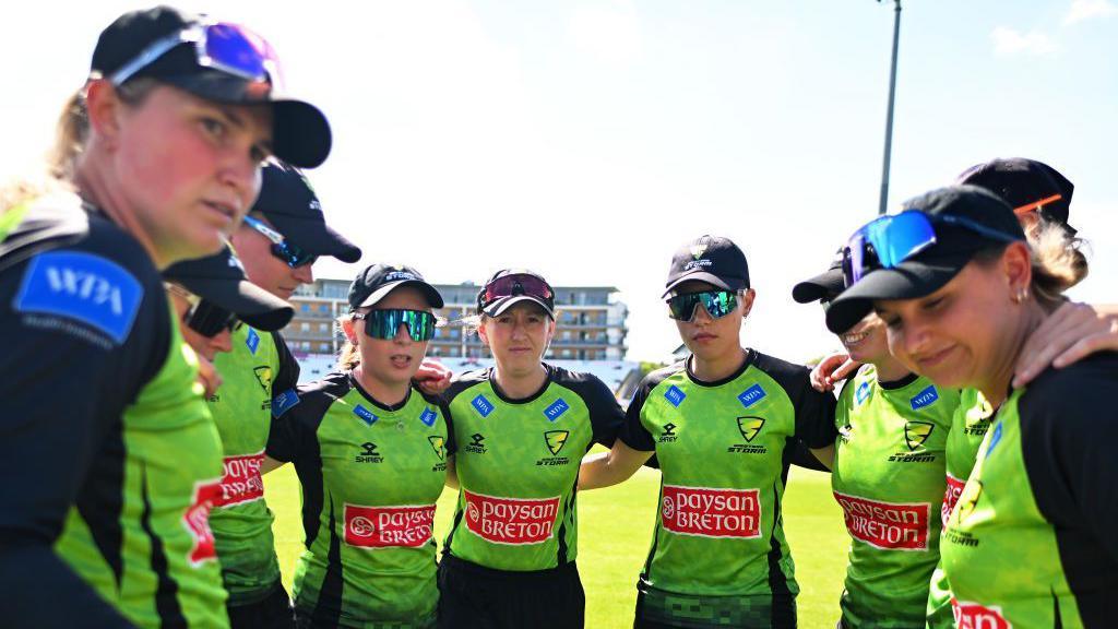 Western Storm players in a huddle on the field this season