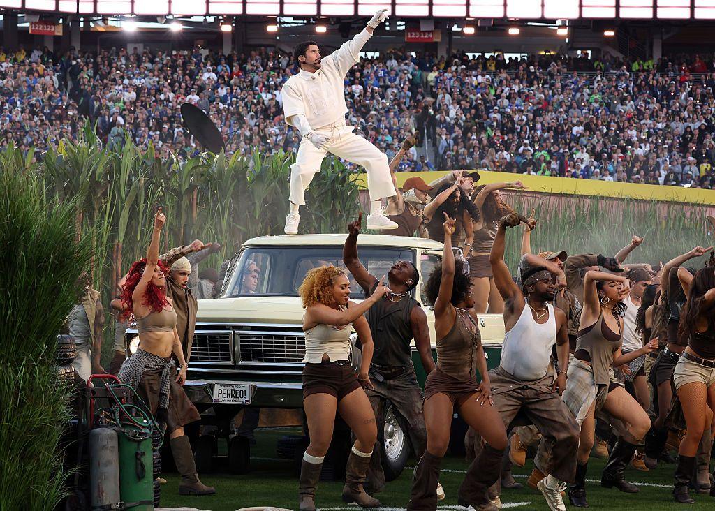 Bad Bunny dances on top of a car surrounded by dancers at the Super Bowl. 