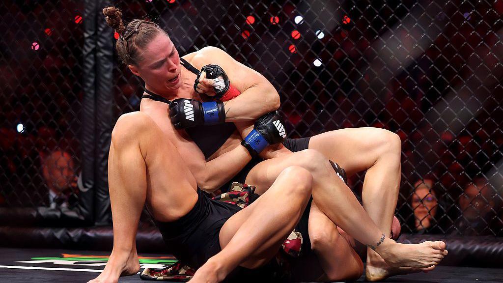 Ronda Rousey uses an armbar on Gina Carano