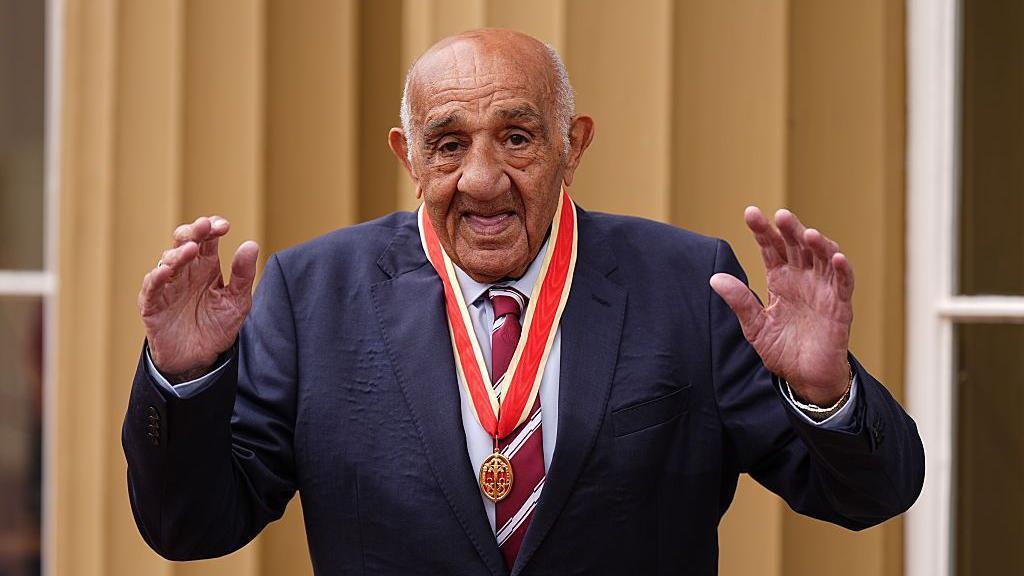 Sir Billy Boston at Buckingham Palace with his medal.