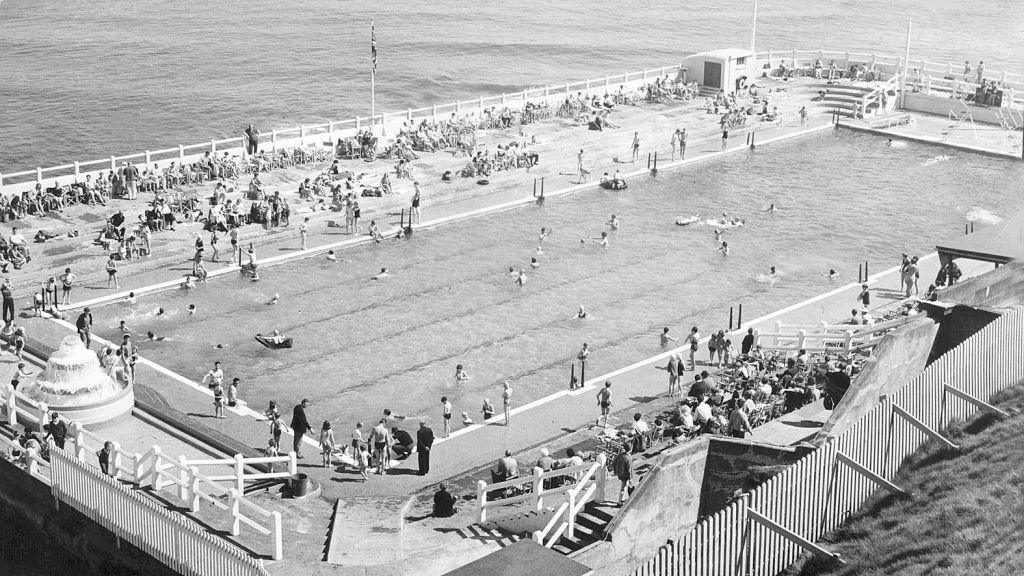 A busy Tynemouth Outdoor Pool pictured in 1966 with people swimming in the pool and relaxing round its edgesm