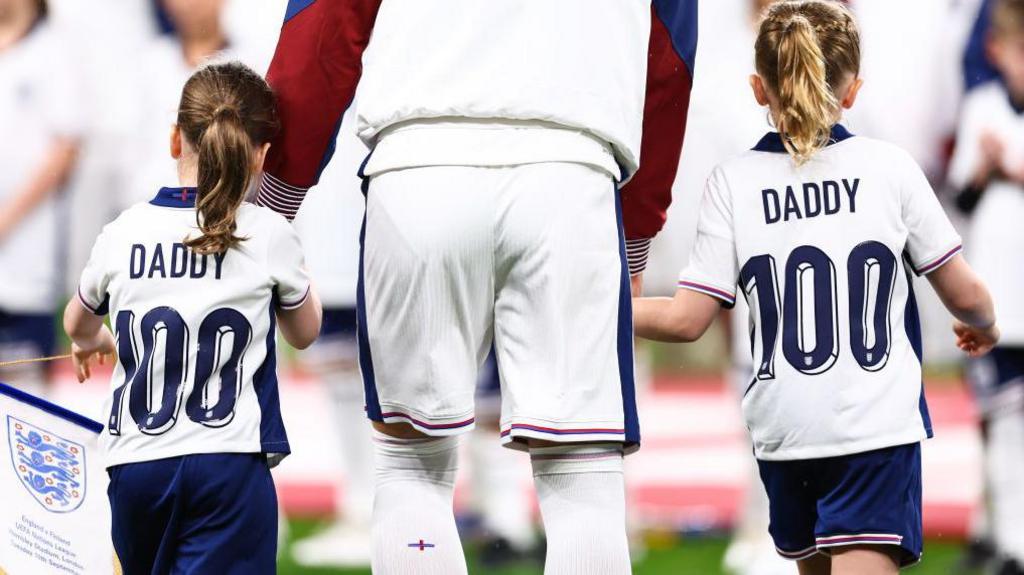 Harry Kane with his children on the pitch