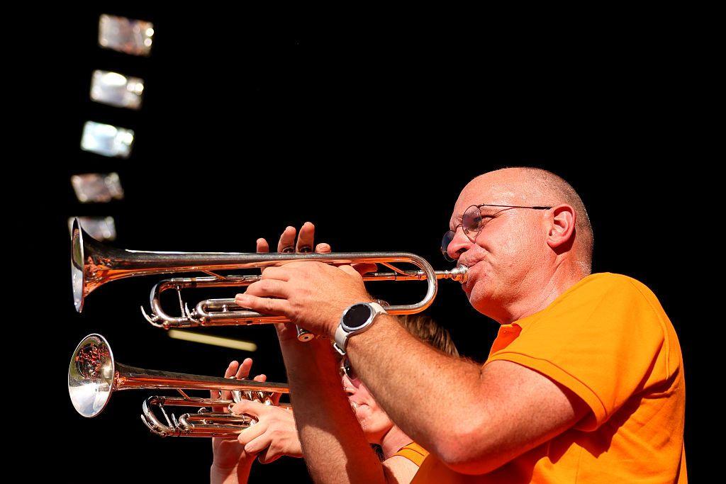 Two Dutch fans play the trumpet during a match
