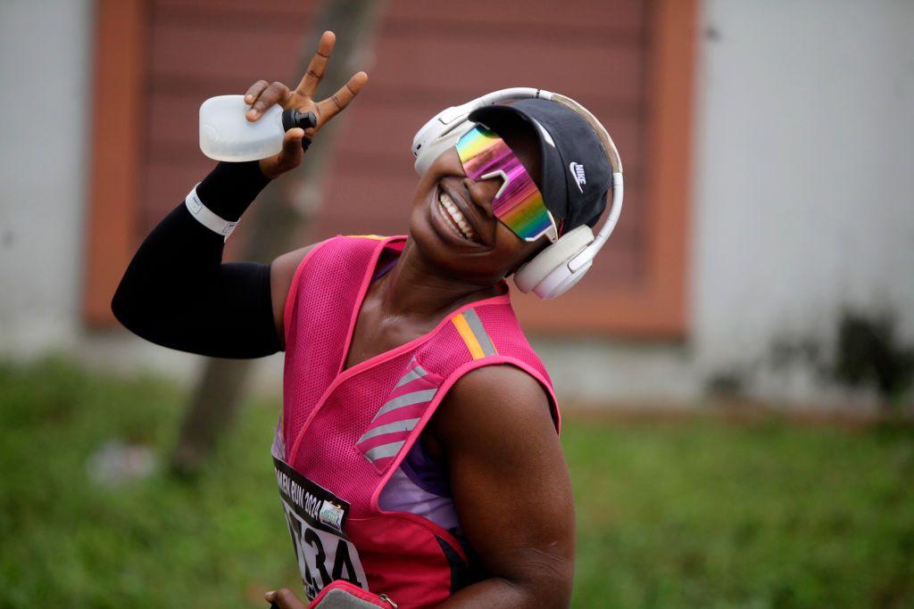 A woman dressed in pink sports gear shows excitement during the ninth edition of the Lagos Women Run 2024, a 10km female road race.