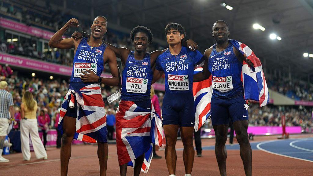 (L-R) Gold medalists Zharnel Hughes, Jeremiah Azu, Louie Hinchliffe and Romell Glave of Team Great Britain pose for a photo after victory in the Men's 4x100 Metres Relay Final